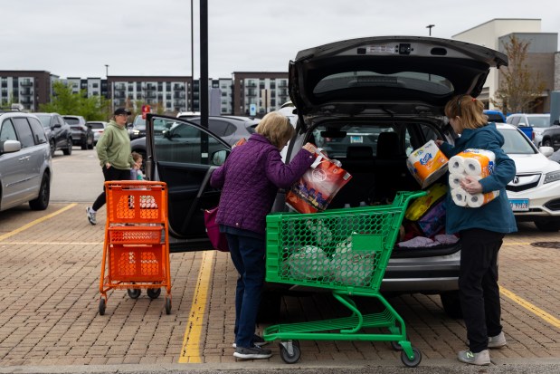 Carol Flood, left, and her sister, Judy Naper, load grocery items after shopping at an Amazon Fresh on Dempster Street on May 2, 2025, in Morton Grove. Morton Grove is one town that has recently approved a 1% grocery tax. (Audrey Richardson/Chicago Tribune)
