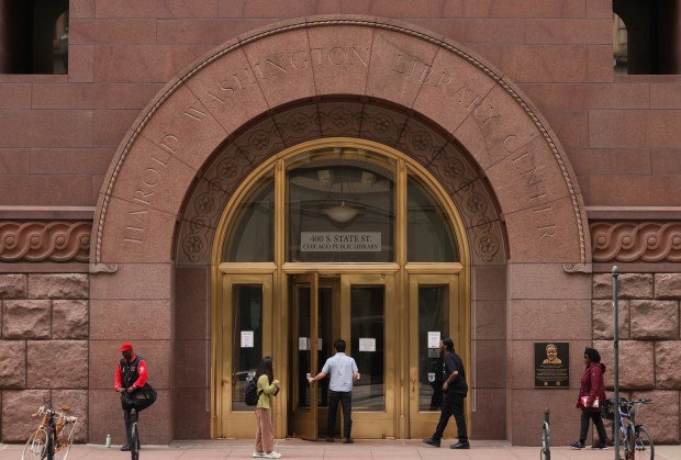 Visitors enter the Harold Washington Library Center, April 29, 2025, in Chicago. (John J. Kim/Chicago Tribune)