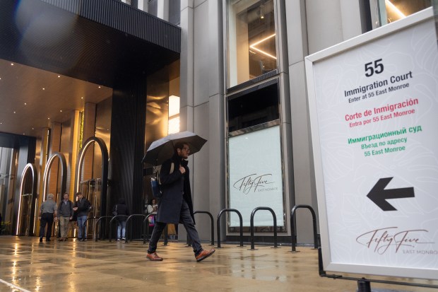 People enter and exit the office space at 55 E. Monroe St. in downtown Chicago, which is home to the Chicago Immigration Court, May 21, 2025. (Audrey Richardson/Chicago Tribune)