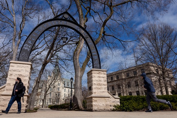People walk by the arch on the Northwestern University campus in Evanston on March 31, 2025. (Brian Cassella/Chicago Tribune)