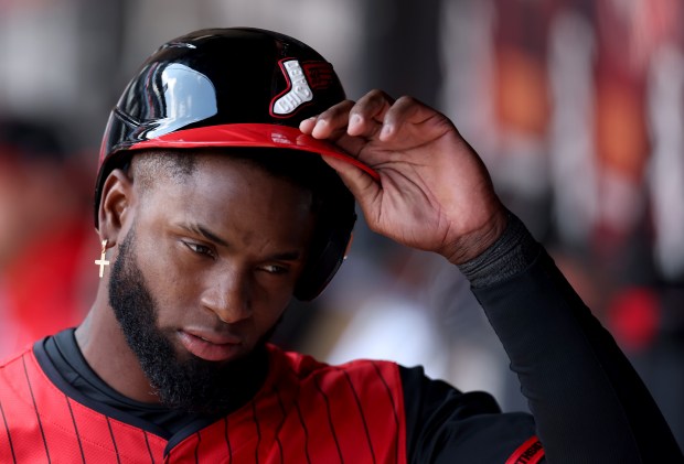 White Sox designated hitter Luis Robert Jr. takes off his helmet in the dugout after striking out to end the third inning against the Astros on May 3, 2025, at Rate Field. (Chris Sweda/Chicago Tribune)
