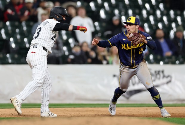 Chicago White Sox outfielder Andrew Benintendi is tagged out at third base by Milwaukee Brewers third baseman Caleb Durbin to end the fifth inning of a game at Rate Field in Chicago on April 30, 2025. (Chris Sweda/Chicago Tribune)