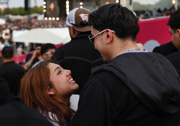 A couple shares a moment during a performance by Peso Pluma at Sueños Music Festival in Chicago's Grant Park on May 24, 2025. (Chris Sweda/Chicago Tribune)