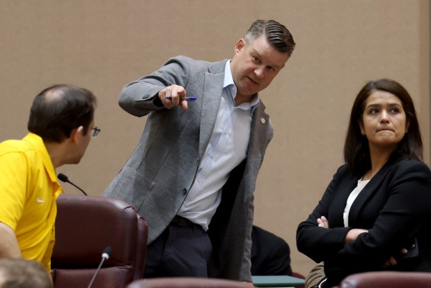 Ald. Bill Conway, 34th, is flanked by Ald. Raymond Lopez, 15th, and Ald. Silvana Tabares, 23rd, as they talk during a meeting of City Council's Public Safety Committee, April 30, 2025. The committee advanced a proposal to give Chicago's top public safety leaders the power to declare "snap curfews" in an effort to curb so-called teen takeovers. (Antonio Perez/Chicago Tribune)