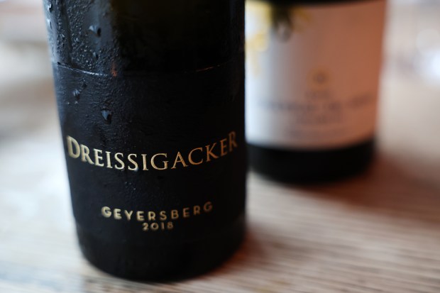 A 2018 Dreissigacker Geyersberg Riesling is seen on the table as Adam Caldwell and Patrick Rauber sample wine while eating at Donkey Table Stick in Chicago on May 1, 2025, as the duo prepares for their upcoming Silvaner Summit event. (Chris Sweda/Chicago Tribune)