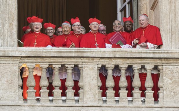 Cardinals, including Chicago Cardinal Blase Cupich, far left, on a balcony next to the central balcony where the new pope was to appear following his election at St. Peter's Basilica in Vatican City, on May 8, 2025. Robert Francis Prevost, taking the name Pope Leo XIV, was elected the 267th pope of the Roman Catholic Church on Thursday, becoming the first pope from the U.S. (Gianni Cipriano/The New York Times)