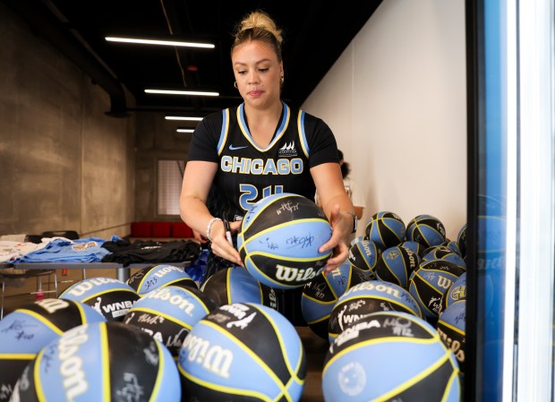 Sky guard Rachel Banham autographs basketballs at media day Monday, May 12, 2025. (Eileen T. Meslar/Chicago Tribune)