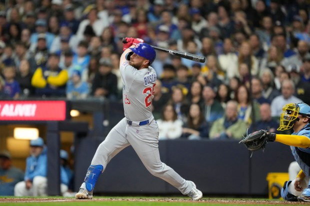 Cubs first baseman Michael Busch watches his grand slam in the second inning against the Brewers on May 2, 2025, at American Family Field in Milwaukee. (Patrick McDermott/Getty Images)