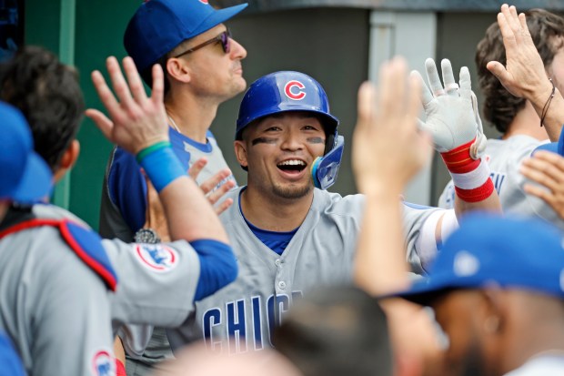 Cubs designated hitter Seiya Suzuki, center, gets high-fives from teammates in the dugout after hitting a two-run home run in the seventh inning against the Pirates on May 1, 2025, in Pittsburgh. (Justin K. Aller/Getty Images)