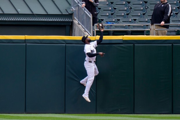 White Sox center fielder Luis Robert Jr. leaps to take a grand slam away from Brewers first baseman Rhys Hoskins in the first inning on May 1, 2025, at Rate Field. (Matt Dirksen/Getty Images)