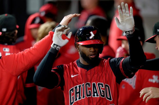 White Sox center fielder Luis Robert Jr. gets high-fives in the dugout after hitting a solo home run in the fifth inning against the Astros on May 2, 2025, at Rate Field. (Matt Dirksen/Getty Images)