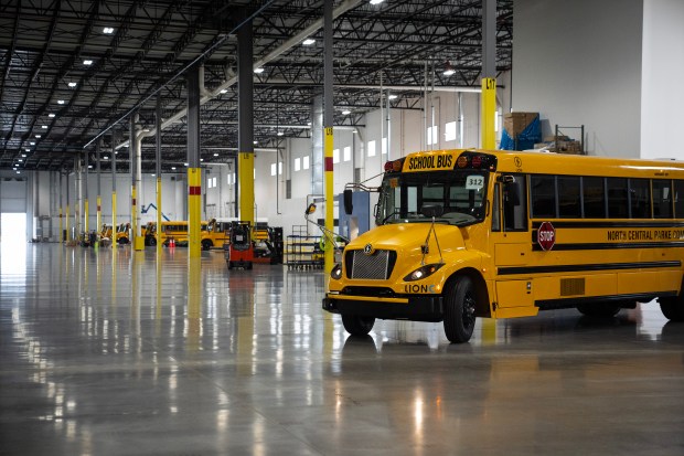 Electric school buses receive finishing touches before being delivered to customers at the Lion Electric Joliet plant on July 23, 2024. (E. Jason Wambsgans/Chicago Tribune)
