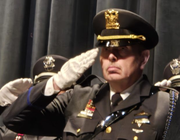 Elgin police Sgt. Rob Copeland gives a salute Friday in memory of officers killed in the line of duty last year during the Elgin Police Department's Memorial Day Service at The Hemmens Cultural Center in Elgin. (Gloria Casas/The Courier-News)