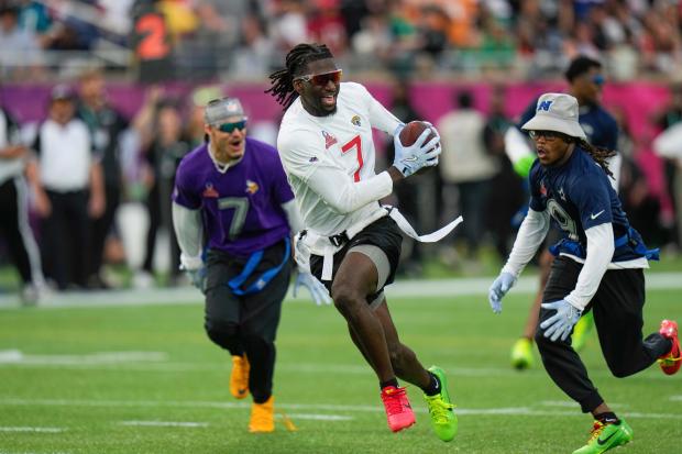 AFC wide receiver Brian Thomas Jr. of the Jaguars runs away from NFC return specialist KaVontae Turpin of the Cowboys, right, during the flag football event at the NFL Pro Bowl on Feb. 2, 2025, in Orlando, Fla. (AP Photo/Chris O'Meara)