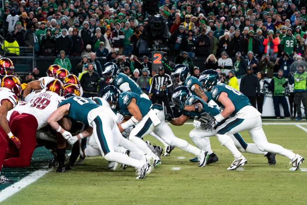 Eagles quarterback Jalen Hurts and teammates run the tush push play during the NFC championship game against the Commanders on Jan. 26, 2025, in Philadelphia. (AP Photo/Chris Szagola)