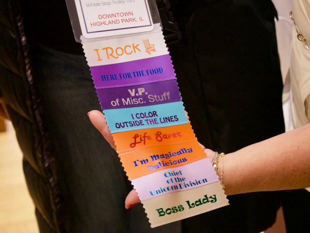 A growing list of ribbons gathered during Thursday's trolley tour of women-owned businesses in Highland Park. Each ribbon gave the participant an additional raffle ticket during the event's afterparty. (Joe States/Lake County News-Sun)