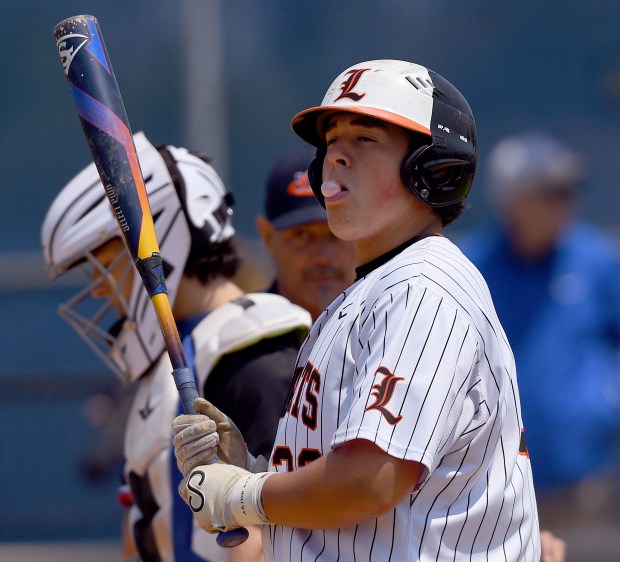 Libertyville's Carson Holmes walks to the plate to bat
