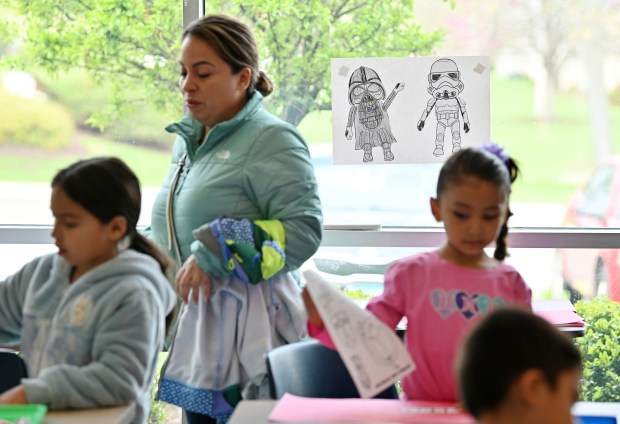 Standing, Vanessa Mora of Zion is among parents in the coloring room featuring Star Wars themed art at Star Wars Day on May 3, 2025 at the Zion-Benton Public Library District in Zion. (Karie Angell Luc/Lake County News-Sun)