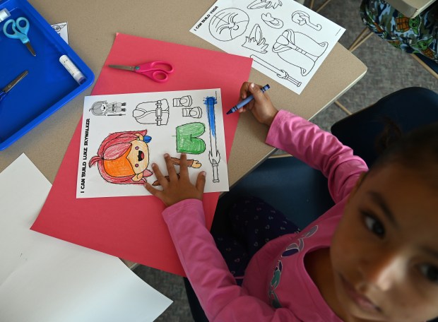 Valentina Serrato, 5, of Zion, colors Star War themed coloring sheets at Star Wars Day on May 3, 2025 at the Zion-Benton Public Library District in Zion. (Karie Angell Luc/Lake County News-Sun)