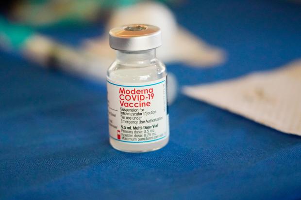 A vial of Moderna COVID-19 vaccine rests on a table at an inoculation station in Jackson, Miss., on July 19, 2022. (AP Photo/Rogelio V. Solis, File)
