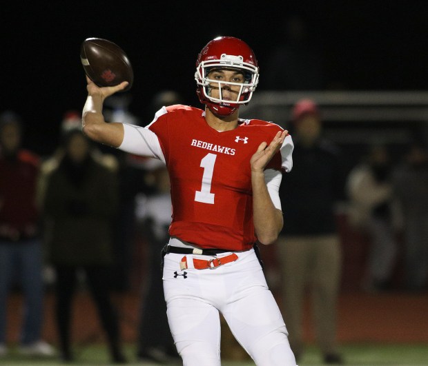 Naperville Central quarterback Payton Thorne passes the ball