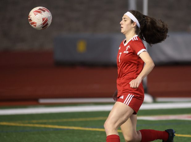 Naperville Central's Bella Brozek plays the ball