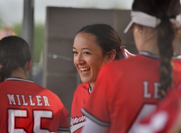 Naperville Central's Natalie Lau enjoys conversation with teammates in the dugout during a game at Metea Valley on Monday, May 19, 2025 in Aurora.(Jon Cunningham/for The Naperville Sun)
