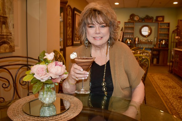 Cathy Bouchard holds a chocolate martini, one of many delights found at Le Chocolat du Bouchard. She opened the business in 2007 in downtown Naperville. (Steve Metsch/Naperville Sun)