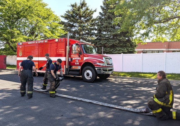 Courtney Bass, right, goes through a training exercise during a spring fire academy at Naperville Fire Station #4 on Friday, May 23, 2025. (Tess Kenny/Naperville Sun)