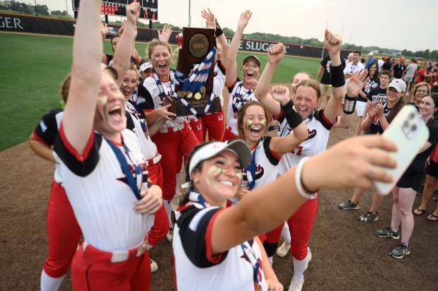 Marist films a TikTok with the first-place trophy after defeating Yorkville in the Class 4A state championship game at the Louisville Slugger Sports Complex in Peoria on Saturday, June 10, 2023.