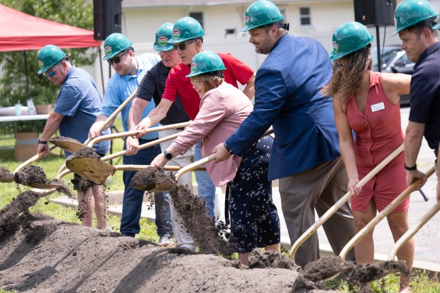 Porter County Public Library employees and Portage officials take a scoop of dirt during a groundbreaking celebration for the Portage Library Garden on Thursday, July 20, 2023. (Kyle Telechan for the Post-Tribune)