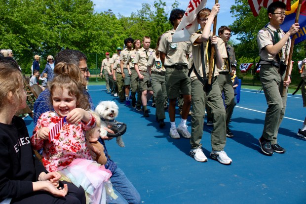 Paisley Leonard, 6 years old, Elouise Leonard, 3 years old, Jeff Frank, and Leo Leonard, 1 year old, from Deerfield, during Monday's Village of Lincolnshire Memorial Day Commemoration at Spring Lake Park. (Gina Grillo/ for the Pioneer Press)