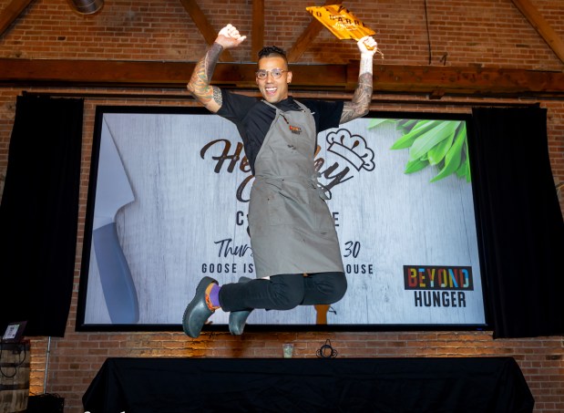 Chef Nathan Cheatham, of of SavorWe, jumps for joy after being named the winner at the 2024 Healthy Chef Challenge that benefited Beyond Hunger, formerly the Oak Park River Forest Food Pantry. (Photos For Food)