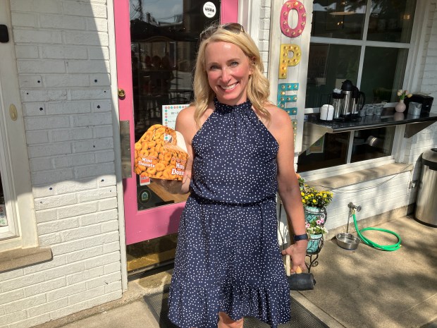 McClure Junior High English Language Arts teacher Tammy Sluis patronizes Bb's Baby Donuts in Western Springs last week after one of her students planted a poem in honor of the establishment. (Hank Beckman/Pioneer Press)