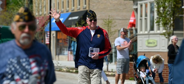 Tom Kittler of Northbrook, retired brigadier general who served in the U.S. Air Force for 32 years, both active and reserve, and is of the Glenbrook North High School Class of 1979, waves as he walks the Shermer Road Memorial Day parade route on May 26, 2025 in Northbrook. (Karie Angell Luc/Pioneer Press)