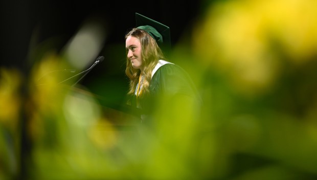 A smile at the conclusion of the senior speech. Maya Heller of Buffalo Grove leaves the podium after speaking at the Adlai E. Stevenson High School commencement at NOW Arena in Hoffman Estates on May 23, 2025. (Karie Angell Luc/Pioneer Press)
