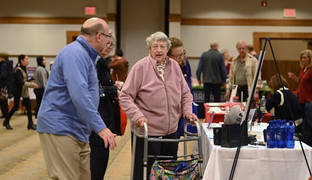 Center, in pink sweater, is patron Donna Myers of Mundelein at the GLMV Extreme Block Party Family Expo and Taste of the Towns on May 3, 2025 in Mundelein at the DoubleTree by Hilton Hotel Mundelein. (Karie Angell Luc/Pioneer Press)