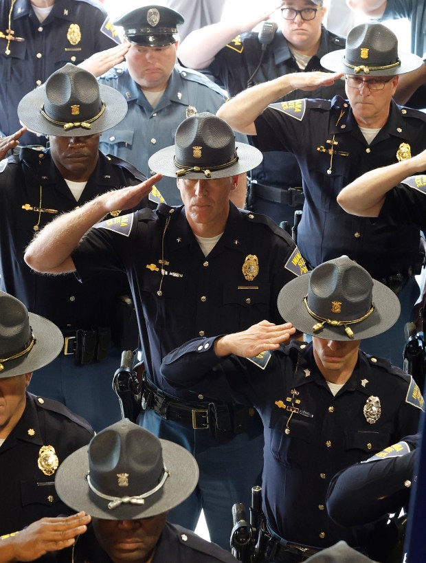 State Troopers salute the colors during an annual memorial service for officers killed in the line of duty held at the Indiana State Police post in Lowell on May 20, 2025. (John Smierciak / for the Post-Tribune)