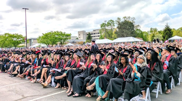 IU Northwest graduates gaze at a big screen during Wednesday's commencement. About 76% of the graduates were women. (Carole Carlson/Post-Tribune)