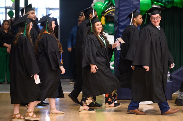 Soon-to-be graduates smile and laugh as they make their way into the gymnasium of the Dean and Barbara White Community Center during Ivy Tech Lake County's Class of 2025 graduation ceremony in Merrillville on Thursday, May 8, 2025. (Kyle Telechan/for the Post-Tribune)