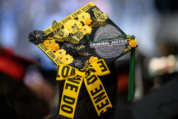 A soon-to-be graduate dons a cap with a "criminal justice" motif during Ivy Tech Lake County's Class of 2025 graduation ceremony in Merrillville on Thursday, May 8, 2025. (Kyle Telechan/for the Post-Tribune)