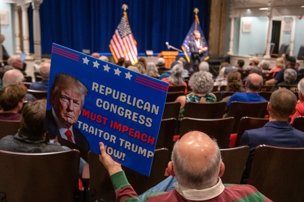 Mike Richards, of Valparaiso, holds a sign during a town hall held by U.S. Rep. Frank Mrvan, D-Highland, at the Memorial Opera House in Valparaiso, Indiana, Thursday, May 29, 2025. Mrvan is holding a series of community conversations throughout the region to give folks updates on what's been going on in DC and address their concerns here. (Andy Lavalley/for the Post-Tribune)
