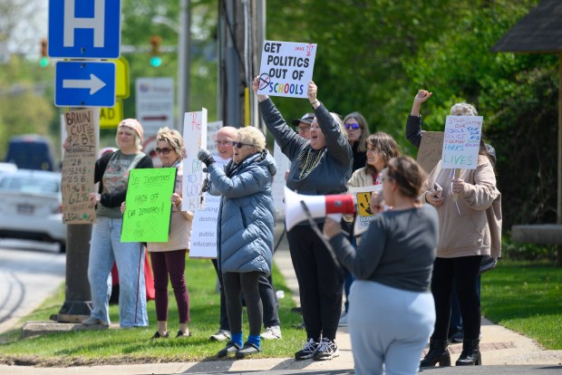 Protesters cheer as they elicit a honk from a passing car during a protest of a visit by Indiana Governor Mike Braun to speak at the Munster Chamber of Commerce May meeting on Thursday, May 8, 2025. (Kyle Telechan/for the Post-Tribune)