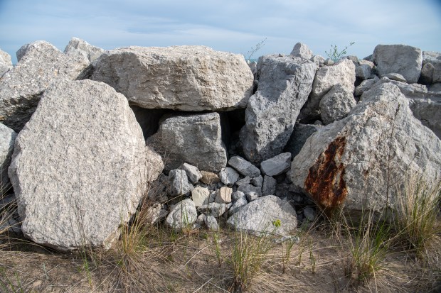 Stones of all sizes have been put in place to try to halt the erosion of sand along the Lake Michigan shoreline in Ogden Dunes, Indiana Tuesday April 29, 2025. Ogden Dunes started constructing a stone revetment wall despite an ongoing legal challenge with Save the Dunes over whether the project violates the public trust.(Andy Lavalley/for the Post-Tribune)