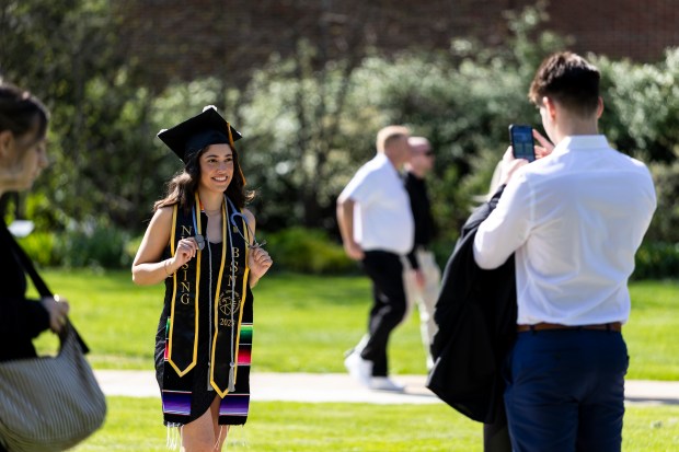 Elisa Roldan poses as Armando Salinas takes a photo of her before commencement at Purdue University Northwest, on Saturday, May 10, 2025, in Hammond. (Vincent D. Johnson / for the Post-Tribune)