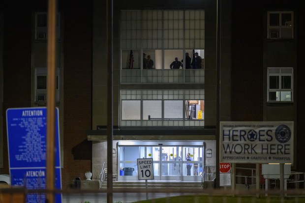 Officers gather in a window at Indiana State Prison as staff prepares to execute inmate Benjamin Ritchie on Monday, May 19, 2025. (Kyle Telechan/for the Post-Tribune)