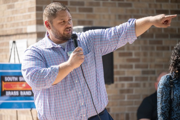 Porter County Public Library System director Jesse Butz points toward the South Haven branch's new public library garden during a ribbon-cutting celebration for the facility on Thursday, Aug. 22, 2024. (Kyle Telechan/for the Post-Tribune)