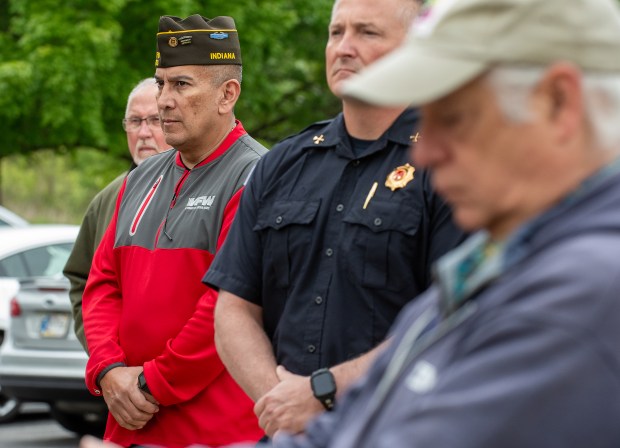 U.S. Army veteran George Perez stands with others during the Memorial Day ceremony at the Service Memorial at Foundation Meadows in Valparaiso, Indiana, Friday, May 23, 2025. Perez, of Valparaiso, served in operations for 27 years. (Andy Lavalley/for the Post-Tribune)
