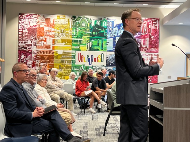 David Nie, a partner with Ice Miller, on right, discusses Valparaiso University's request for the city of Valparaiso to serve as a conduit for a $117 million general obligation bond during a city council meeting May 12, 2025. (Philip Potempa/for Post-Tribune)