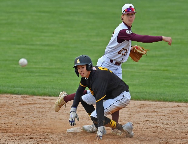 As he breaks up a double play Andrew's Austin Cusack watches for the outcome at first base along with Lockport's Zack Skrzypiec (23) during a game on Thursday, May 22, 2025 in Lockport.(Jon Cunningham for the Daily Southtown)